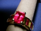 The red stones are synthetic rubies with real peridots. spelling?